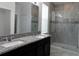 Bathroom with granite double vanity, large shower, and tile flooring at 2180 Nighthawk Dr, Haines City, FL 33844