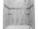 Shower with grey tile and glass enclosure at 2180 Nighthawk Dr, Haines City, FL 33844