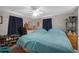 Bedroom with two twin beds, ceiling fan, and shoe rack at 6055 Grand Oaks Se Dr, Winter Haven, FL 33884