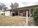 Covered carport area with storage and yard space at 6055 Grand Oaks Se Dr, Winter Haven, FL 33884