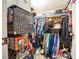 Well-organized closet with clothing, hats, and shelving units at 6055 Grand Oaks Se Dr, Winter Haven, FL 33884
