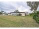 Tan mobile home with large windows and mature tree at 6055 Grand Oaks Se Dr, Winter Haven, FL 33884