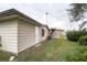 Tan house exterior with storage shed and yard at 6055 Grand Oaks Se Dr, Winter Haven, FL 33884