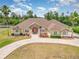 House with solar panels, circular driveway, and lush landscaping at 2715 Sw 177Th Place Rd, Ocala, FL 34473