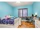 Bright bedroom with a double bed, a desk, and wood flooring at 2715 Sw 177Th Place Rd, Ocala, FL 34473