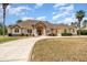 Single-story house with stone accents, landscaping, and circular driveway at 2715 Sw 177Th Place Rd, Ocala, FL 34473