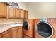 Laundry room with washer, dryer, and cabinets at 2715 Sw 177Th Place Rd, Ocala, FL 34473