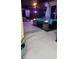 Night view of a pool and fire pit with covered patio at 2715 Sw 177Th Place Rd, Ocala, FL 34473