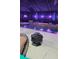 Enclosed pool area with fire pit, lounge chairs, and colorful lighting at 2715 Sw 177Th Place Rd, Ocala, FL 34473