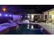 Night view of a pool and spa with covered patio at 2715 Sw 177Th Place Rd, Ocala, FL 34473