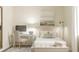 Bright bedroom with a bed, desk, and neutral decor at 4807 Waltham Forest Dr, Davenport, FL 33837
