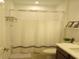 Bathroom featuring shower with white shower curtain and vanity with decor at 621 San Augusto Dr, Poinciana, FL 34759