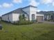 Attractive home featuring manicured lawn, updated landscaping, and a side-entry two-car garage at 621 San Augusto Dr, Poinciana, FL 34759