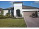 Charming single-Gathering home with well-maintained lawn, brick driveway, and neutral color palette at 621 San Augusto Dr, Poinciana, FL 34759