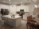 Bright kitchen with a center island, stainless appliances, white cabinetry, and modern lighting at 621 San Augusto Dr, Poinciana, FL 34759