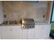 This outdoor kitchen features granite counters, a stainless steel grill, and white cabinets for ample storage space at 621 San Augusto Dr, Poinciana, FL 34759