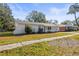 Ranch-style home with a spacious yard and mature trees at 631 Swiss Dr, Lakeland, FL 33810