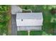 Directly above view of home, highlighting metal roof and landscaping at 1528 Walker Rd, Lakeland, FL 33810