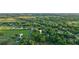 Aerial view showing home on large lot with surrounding trees and open fields at 1528 Walker Rd, Lakeland, FL 33810