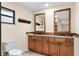 Bathroom boasts double sinks, wood cabinets, and tile flooring at 1528 Walker Rd, Lakeland, FL 33810