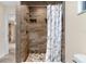 Bathroom with walk-in shower and stone tile at 1528 Walker Rd, Lakeland, FL 33810
