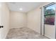 Bright bedroom with tile flooring and window overlooking trees at 1528 Walker Rd, Lakeland, FL 33810