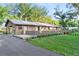Brick ranch house with attached carport and landscaped yard at 1528 Walker Rd, Lakeland, FL 33810