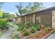 Brick ranch house with metal roof, landscaping, and a long driveway at 1528 Walker Rd, Lakeland, FL 33810