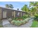 Brick home with covered porch, landscaping, and a walkway at 1528 Walker Rd, Lakeland, FL 33810
