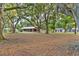 Ranch-style home with covered porch, surrounded by mature trees at 1528 Walker Rd, Lakeland, FL 33810
