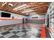 Finished garage with Ford Racing decor and shelving at 1528 Walker Rd, Lakeland, FL 33810