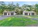 Detached garages with ample parking space and lush lawns at 1528 Walker Rd, Lakeland, FL 33810