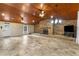 Spacious living room featuring a large stone fireplace and wood beamed ceiling at 1528 Walker Rd, Lakeland, FL 33810