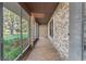 Spacious screened porch with tile flooring and views of the backyard at 1528 Walker Rd, Lakeland, FL 33810