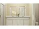 Clean bathroom with double vanity, white cabinets, and a large mirror at 2653 Skyline Loop, Kissimmee, FL 34758