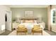 Bright bedroom with a king-size bed, neutral color palette, and two accent chairs at 2653 Skyline Loop, Kissimmee, FL 34758