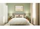 Bedroom with light green walls, a bed, and nightstands with lamps at 2653 Skyline Loop, Kissimmee, FL 34758
