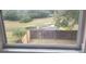View of fenced backyard with a pond visible from a window at 2938 Egrets Landing Dr, Lake Mary, FL 32746