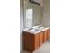 Double vanity bathroom with wood cabinets and large mirror at 2938 Egrets Landing Dr, Lake Mary, FL 32746
