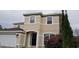 Two-story house with beige exterior, black door, and landscaping at 2938 Egrets Landing Dr, Lake Mary, FL 32746