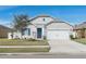 Curb appeal abounds at this charming one-story home featuring a two-car garage and manicured lawn at 3219 Bayou Bay Dr, Lakeland, FL 33811