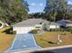 Single-story home with a two-car garage and landscaped yard at 14544 Sw 112Th Cir, Dunnellon, FL 34432