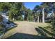 Large backyard with mature trees and a patio area at 14544 Sw 112Th Cir, Dunnellon, FL 34432