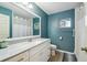 Teal bathroom with white vanity and shower/tub combo at 14544 Sw 112Th Cir, Dunnellon, FL 34432