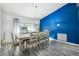 Dining room with large table, chairs, and blue accent wall at 14544 Sw 112Th Cir, Dunnellon, FL 34432