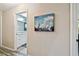 Hallway with art and a view into an additional bathroom at 14544 Sw 112Th Cir, Dunnellon, FL 34432