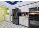 Well-equipped kitchen with black appliances and white cabinets at 14544 Sw 112Th Cir, Dunnellon, FL 34432