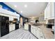 Modern kitchen with white cabinets, granite counters, and black appliances at 14544 Sw 112Th Cir, Dunnellon, FL 34432