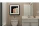 Bathroom with single vanity, neutral tones, and framed art at 1943 Rider Rain Ln, Apopka, FL 32703