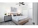 Bedroom with a tan bed, geometric patterned bedding, and nightstands at 274 Puma Loop, Groveland, FL 34736